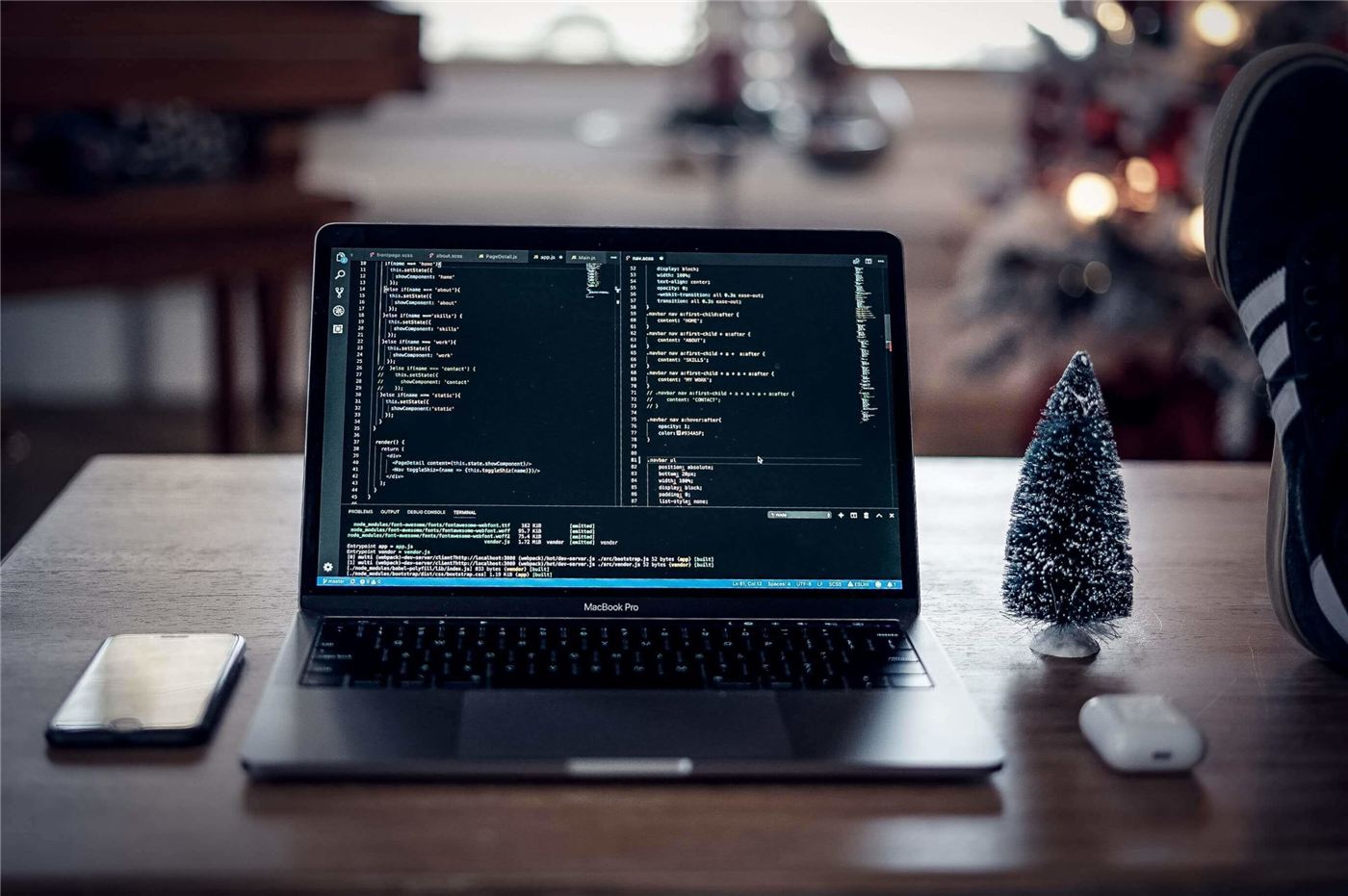 Web developer working on code across two monitors
