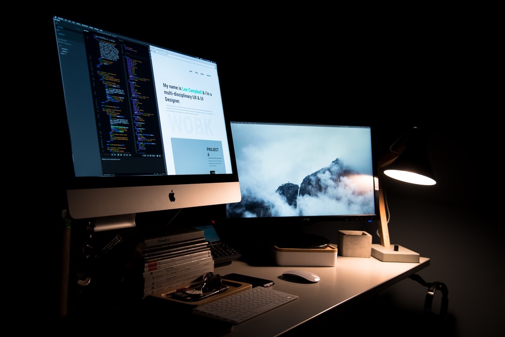 Laptop showing a website design on a desk